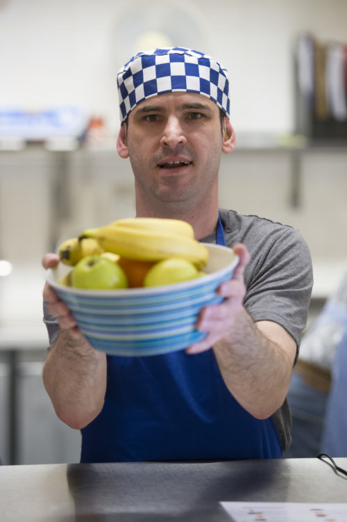 1980s onwards - Bede develops its community services to include people with learning disabilities such as our client at work in our kitchen